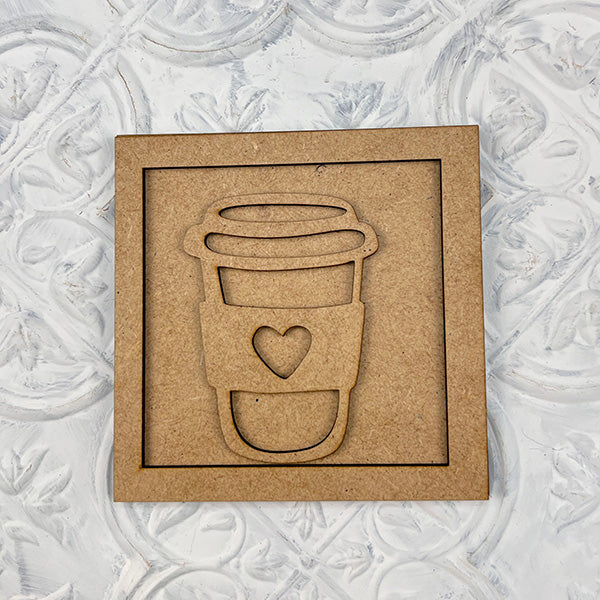 Coffee Squares by Janet's Craft Corner: A brown square cardboard with a to-go coffee cup cutout featuring a heart on the sleeve—ideal for DIY home decor. Set against a white, textured, decorative background.