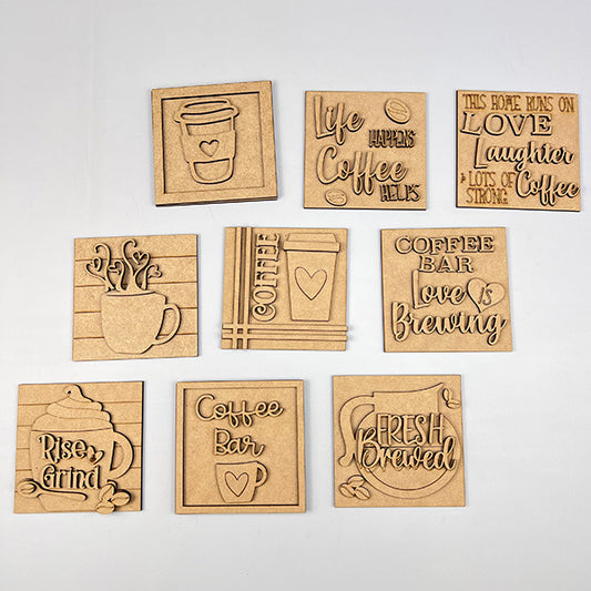 Set of ten "Coffee Squares" by Janet's Craft Corner—square and rectangular wooden plaques with coffee-themed designs like "Life Happens Coffee Helps." Ideal for DIY home decor or adding charm to small spaces. Displayed on a white background.