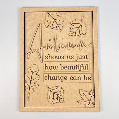 The Autumn Change Shelf Leaner DIY Home Decor Kit from Janet's Craft Corner includes a wooden sign adorned with the quote "Autumn shows us just how beautiful change can be," surrounded by intricately carved leaves. This kit is perfect for enhancing your home décor, as it seamlessly merges nature's beauty with thoughtful design.