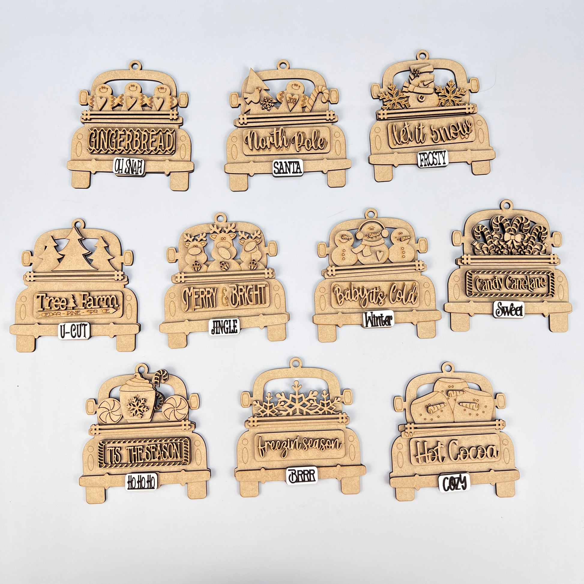 The "Antique Truck Ornament" from Janet's Craft Corner is part of the DIY Decoration Kits, featuring wooden car-shaped designs like "Gingerbread" and "Let It Snow." These charming pieces are perfect for Christmas décor enthusiasts and are beautifully showcased in a grid on a white background.