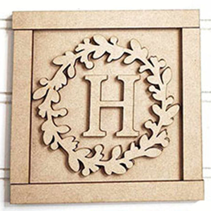 The Monogram Wall Hanging from Janet's Craft Corner is a DIY home decor craft kit featuring a wooden square plaque with a central "H" and a raised wreath-like leaf design, all bordered like a frame. It adds charm and elegance to your space. Set of 1.