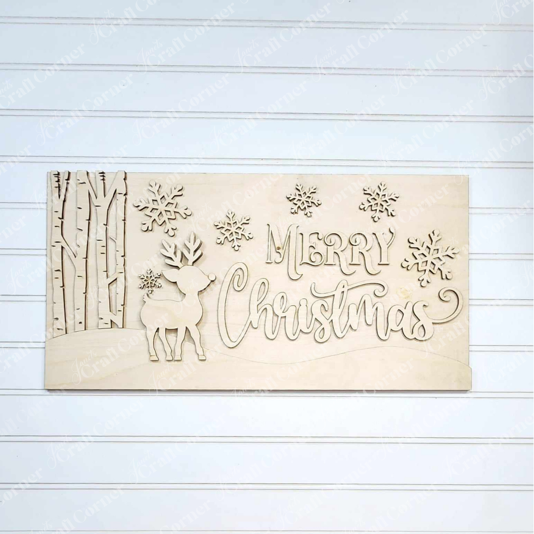 The "Oh Deer Mantle Sign" by Janet's Craft Corner is a hand-painted wooden holiday plaque that showcases a charming reindeer alongside decorative trees on the left. The phrase "Merry Christmas," in the center and surrounded by snowflakes, stands out against a white wooden wall, making it perfect for home décor.