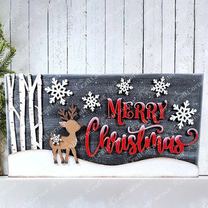 The "Oh Deer Mantle Sign" by Janet's Craft Corner is a festive home décor piece that showcases hand-painted snowflakes, a wooden reindeer, and birch trees on a snowy base. It prominently features the words "Merry Christmas" in red against a dark background.