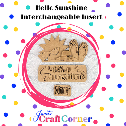 The "Hello Sunshine Interchangeable Insert" by Janet's Craft Corner is a DIY home decor kit with 3 wooden cutouts featuring a sun with sunglasses, flip-flops, and phrases like "Hello Sunshine" and "summer picnic," all framed by a pink circle with colorful polka dots. Perfect for outdoor activity decor.