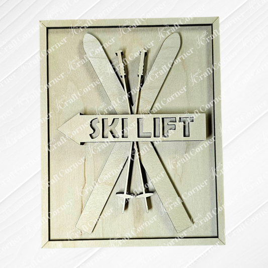 The Ski Lift Interchangeable Sign by Janet's Craft Corner features hand-painted "Ski Lift" text with crossed skis and poles, beautifully framed in wood, making it a charming addition to any DIY craft kit collection or home decor.