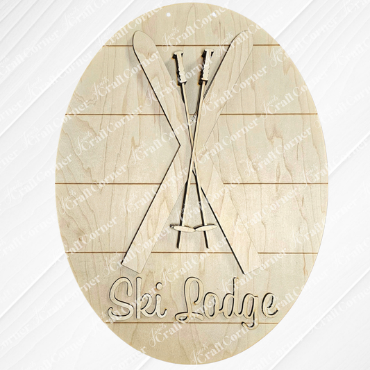 The Ski Lodge Door Hanger by Janet's Craft Corner is an oval wooden sign with engraved crossed skis and poles above the words "Ski Lodge." Its wood panel texture complements any home décor, making it ideal for a DIY craft kit to personalize your cozy mountain retreat.