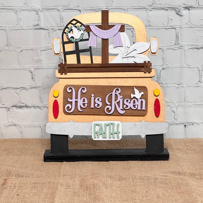 Janet's Craft Corner offers the Antique Truck Base with Insert, a DIY interchangeable home decor kit. Featuring "He is Risen" in purple letters, a cross, window wreath, and "FAITH" on the bumper, it adds a spiritual touch to any rustic setting. Ideal for enhancing your home decor.