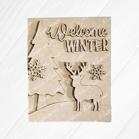 The Welcome Winter Sign from Janet's Craft Corner is a hand-painted wooden plaque showcasing "Welcome Winter" text, adorned with a tree, two snowflakes, and a reindeer. It's an ideal piece of charming home decor to celebrate the season's arrival.