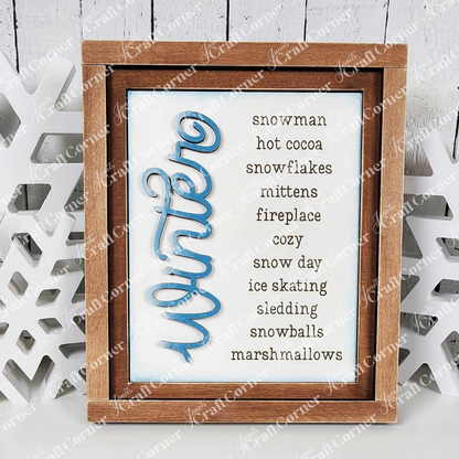 This Janet's Craft Corner farmhouse frame for interchangeable signs features "winter" in blue with words like snowman, hot cocoa, and mittens, plus a snowflake detail. Perfect DIY home decor craft kit for cozy spaces!.