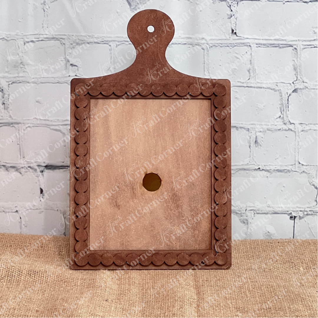 The Bead Trim Breadboard Frame for Switchable Farmhouse Signs by Janet's Craft Corner is a rectangular wooden frame with a scalloped edge and handle, ideal for DIY seasonal home decor or craft kits. Set of 1.