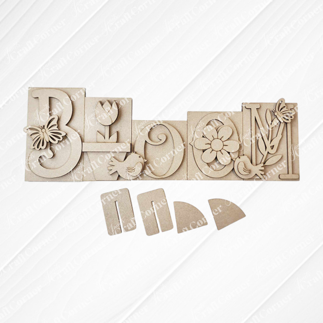 Introducing the "Bloom Word Block Shelf Sitter" from Janet's Craft Corner. This DIY home decor kit features a wood sign with carved letters: butterfly on "B," tulip on "L," bird on "O," flower on the second "O," and leaves with a bird on "M." Easy to assemble for seasonal decor.