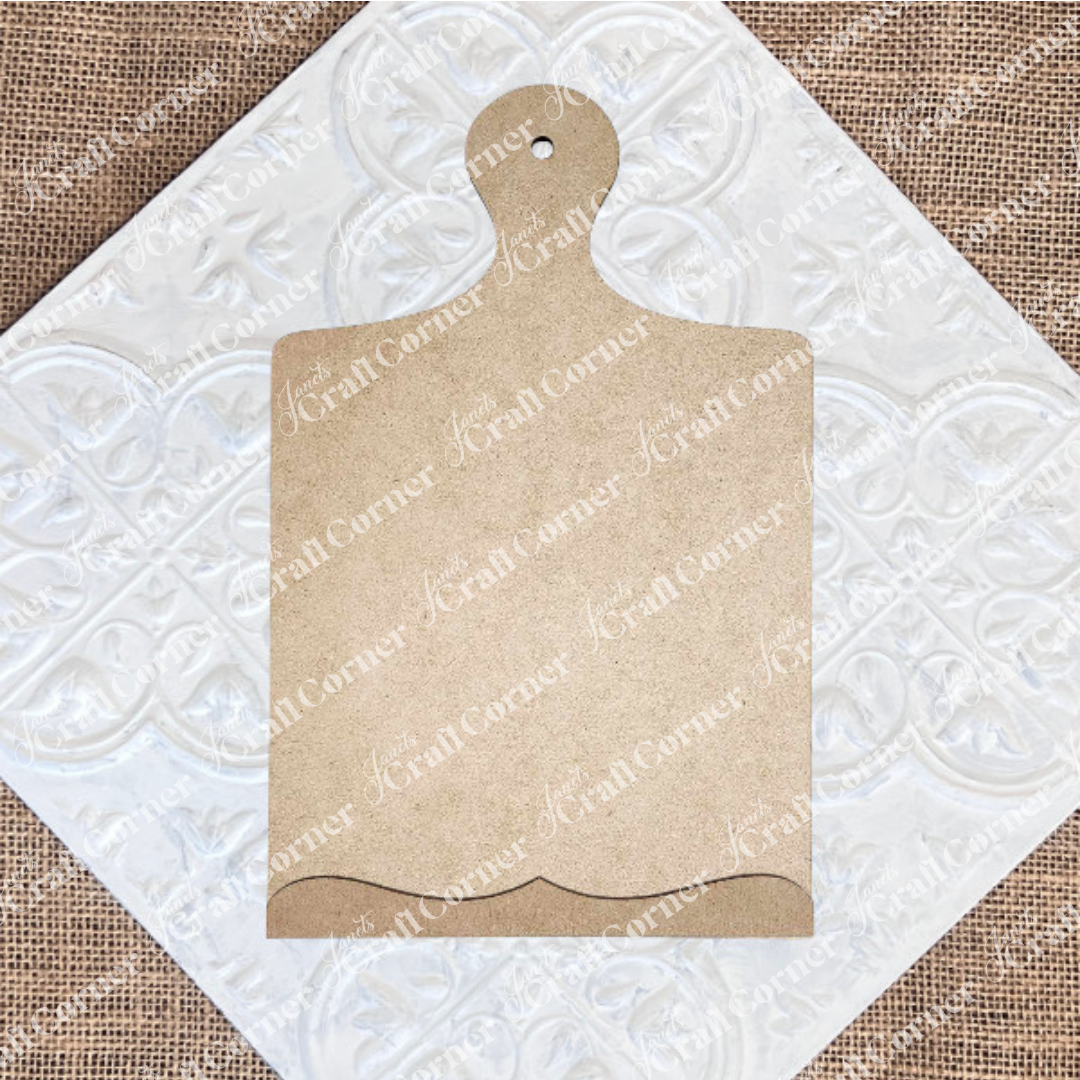 The Breadboard Sign Holder Shelf Sitter by Janet's Craft Corner, a DIY home decor craft kit, features a blank wooden board with a decorative edge and handle—a perfect farmhouse-style accent for your kitchen.