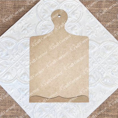 The Breadboard Sign Holder Shelf Sitter by Janet's Craft Corner, a DIY home decor craft kit, features a blank wooden board with a decorative edge and handle—a perfect farmhouse-style accent for your kitchen.