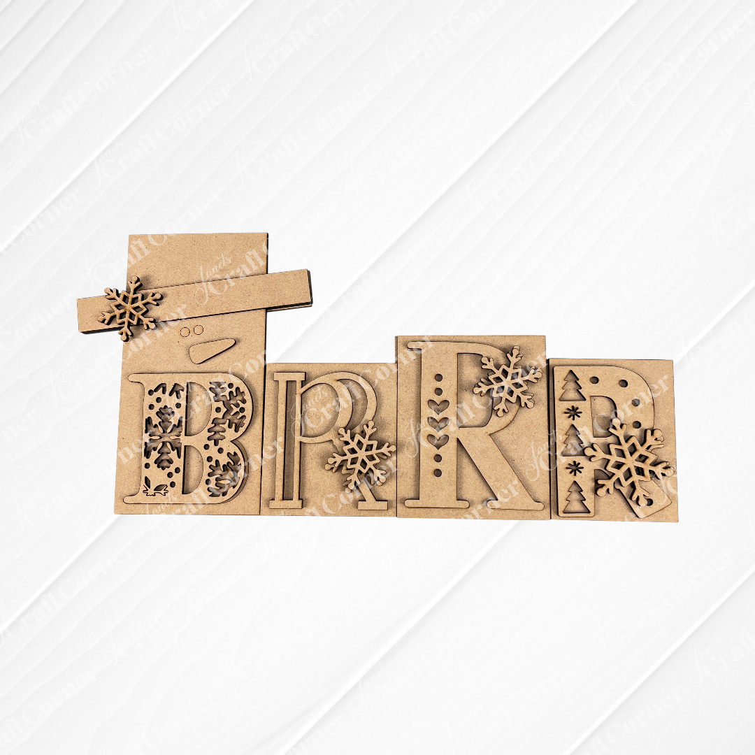 Janet's Craft Corner Brrr Word Block Shelf Sitter DIY craft kit features laser-cut wooden letters with snowflakes, trees, and a snowman’s face and hat on the first "B"—a perfect seasonal home decor set.