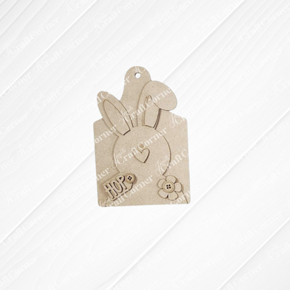 Janet's Craft Corner Easter Mini Shelf Sitters Spring DIY Craft Kit features a blank wooden bunny tag with upright ears, heart, flower, and "HOP" engraving—perfect for Easter decor or DIY crafts. Choose from 3 designs!.