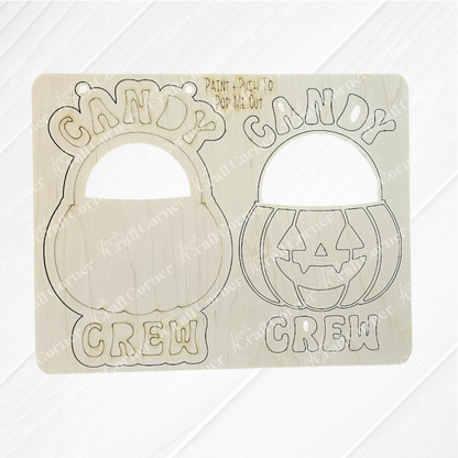 The Janet's Craft Corner Candy Crew Kids Pop-Out includes two wooden cutouts with engraved jack-o’-lantern buckets and “CANDY CREW”—one solid, one with pop-out shapes. Ideal for festive holiday décor or as a fun DIY craft kit for kids.