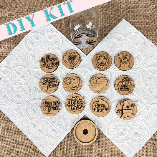 The Candy Jar Interchangeable Set by Janet's Craft Corner is a DIY kit that includes wooden discs with engraved designs, featuring seasonal themes like Halloween and Thanksgiving. The interchangeable inserts are displayed over textured white and burlap backgrounds, with an elegantly positioned empty candy jar in the center.