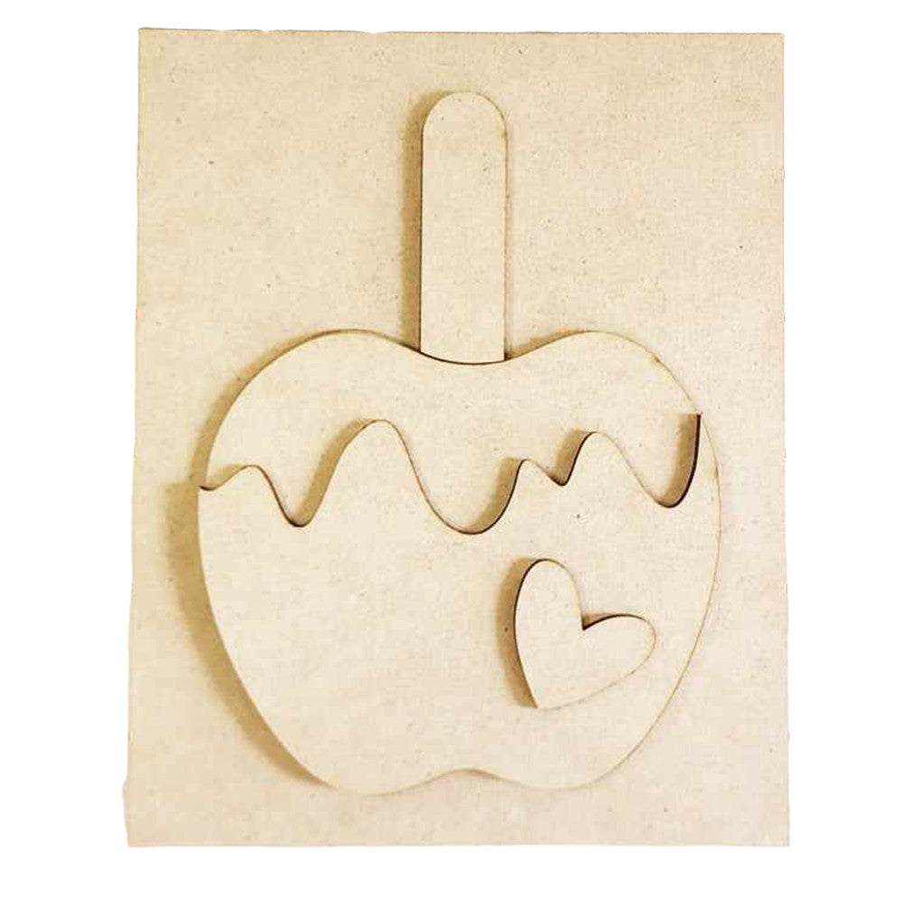 A wooden craft from Janet's Craft Corner features a caramel apple with a wavy caramel design and a heart shape on the front. This DIY home decor piece, known as the Caramel Apple Interchangeable Sign, is ideal as an interchangeable sign and is displayed on a coordinating wooden background.