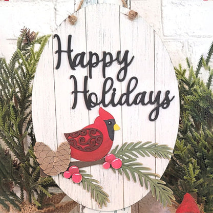 The Cardinal Happy Holidays Door Hanger by Janet's Craft Corner features an oval wooden sign with the phrase "Happy Holidays" in elegant black script. This delightful decoration showcases a red cardinal amid pine branches, pine cones, and vibrant red berries. The green foliage against a white brick wall adds a festive touch, making it perfect for welcoming holiday gatherings.