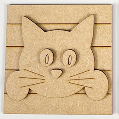 The Cat Swappable Squares by Janet's Craft Corner features a wooden cartoon cat face with big oval eyes, pointy ears, and whiskers on a grooved square—ideal for tiered trays or DIY seasonal home decor projects.