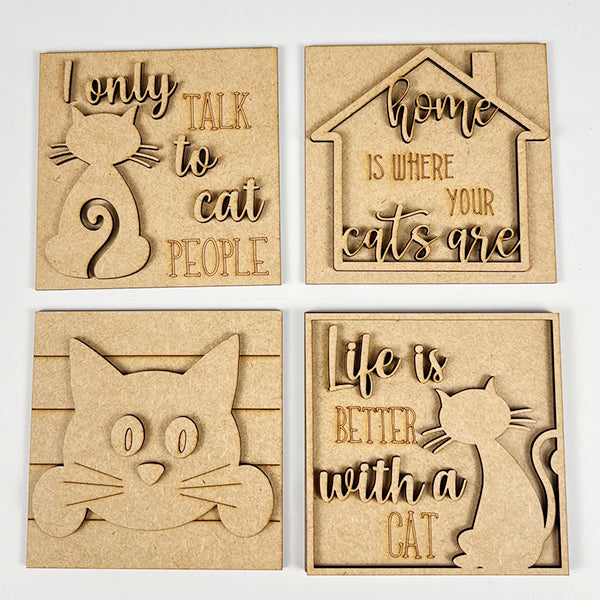 Janet's Craft Corner Cat Swappable Squares are four wooden plaques with cat-themed cut-out designs and engraved cat lover quotes, perfect for DIY seasonal home decor. Includes cat silhouettes, a house outline, and a cat face.