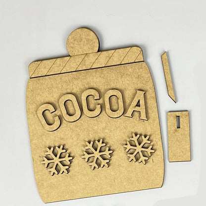 Crafted from wood, the "Hot Cocoa Tiered Tray Pieces" by Janet's Craft Corner feature a cocoa jar design with the word "COCOA" and three snowflakes elegantly engraved on it. This DIY Kit includes a lid and an additional rectangular piece, making it ideal for bringing charm to your holiday décor or enhancing your Hot Cocoa Tiered Tray display.