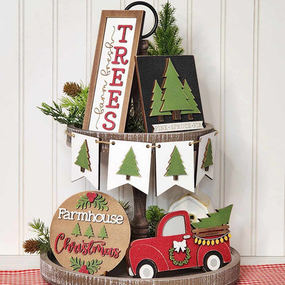 Transform your home décor collection with Janet's Craft Corner's Farmhouse Christmas Tiered Tray DIY Decor Kit. This festive set includes five charming wooden Christmas items such as a quaint red truck, tree cutouts, and a "Farmhouse Christmas" sign. The display is beautifully enhanced with greenery and a tree banner on a white background, making it the perfect holiday addition to your space.