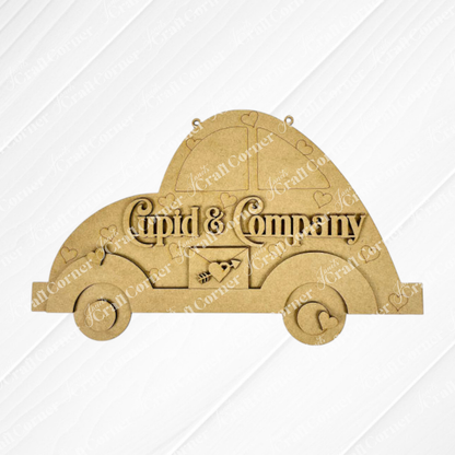 The Cupid Volkswagen Door/Wall Hanger by Janet's Craft Corner features a vintage car wooden cutout with "Cupid & Company," small hearts, and a central heart with an arrow. Ideal for DIY projects, it stands elegantly against a white background.