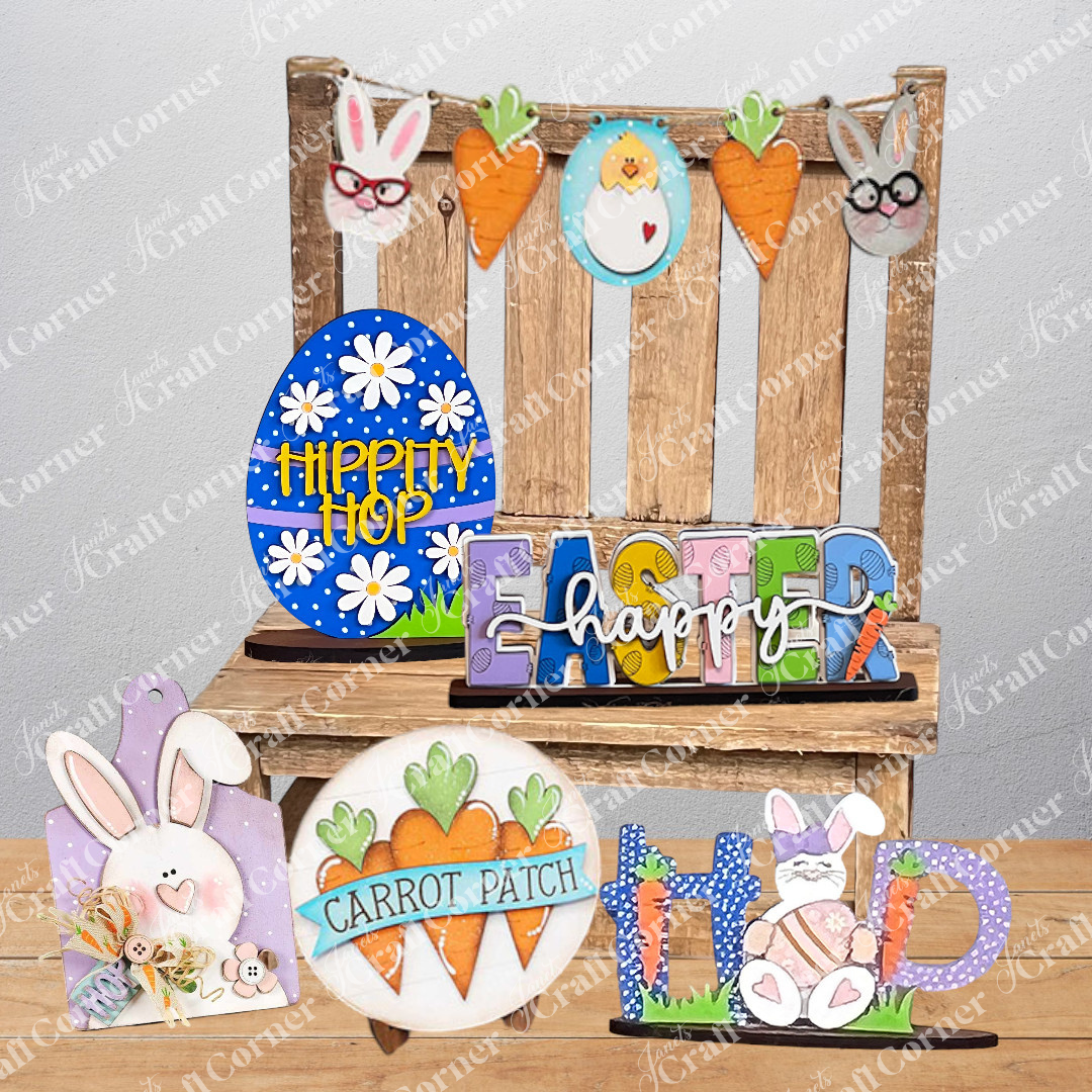 Discover Janet's Craft Corner's "Easter Trio Mini Shelf Sitters," which includes a wooden display featuring "HOP" complete with a bunny and carrots, an egg adorned with "HIPPITY HOP," and vibrant letters spelling out "EASTER happy." Ideal for a DIY kit project, these delightful shelf sitters are beautifully presented on burlap set against a white brick backdrop.