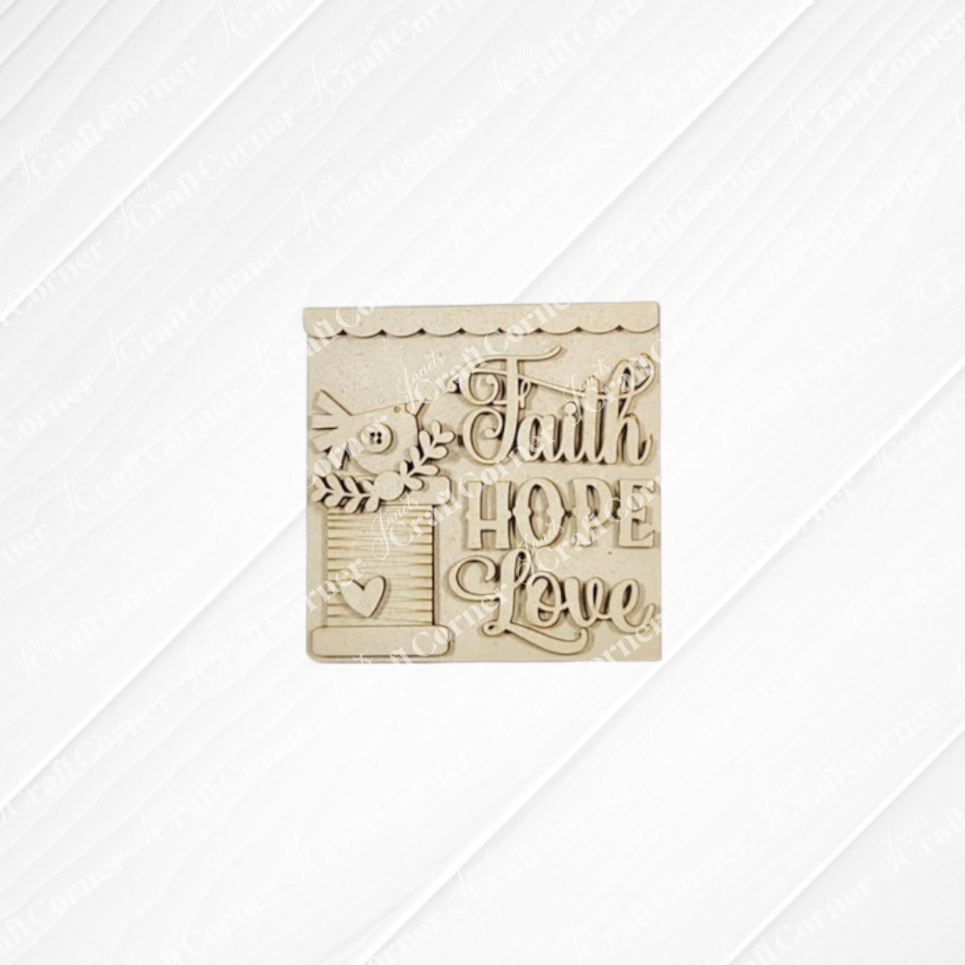 The Heirloom Decor Set from Janet's Craft Corner includes a wooden plaque with a bird, leaves, heart, and “Faith Hope Love” elegantly carved—a charming DIY craft kit for seasonal home decor.