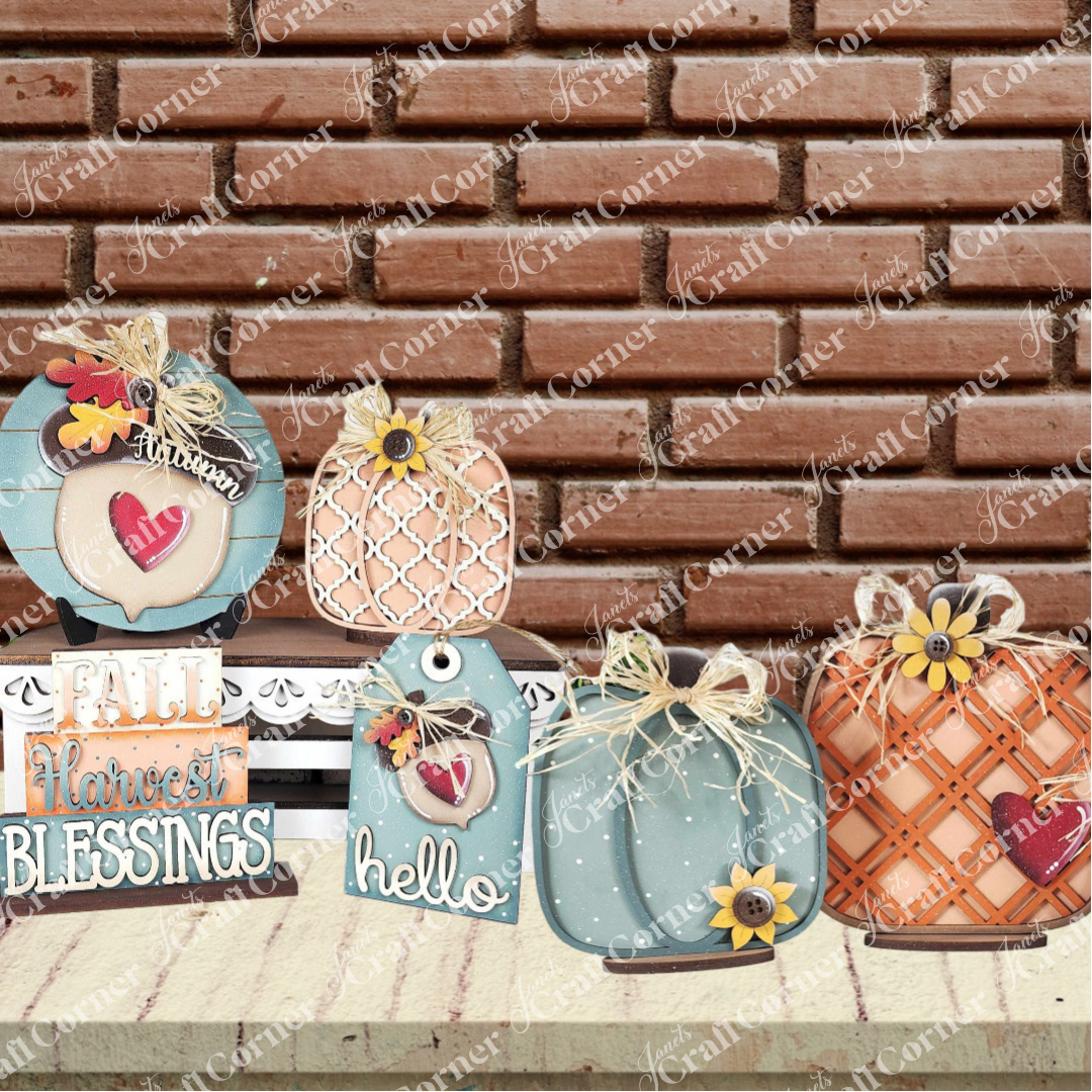 Janet's Craft Corner Fall Harvest Mini Shelf Sitters DIY home decor kit features blue and orange pumpkins, a “fall harvest blessings” sign, and heart and flower tags, perfect for autumn displays on shelves or tables.