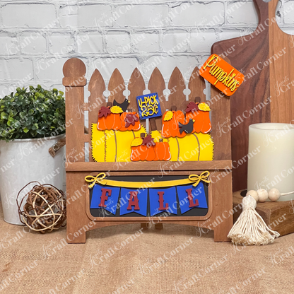 The Fall Hay Bale Interchangeable Insert by Janet's Craft Corner is a DIY seasonal home decor kit (1 set of 3 pieces) featuring autumn colors, pumpkins, and a "Happy Fall" sign. Easily update your décor with interchangeable inserts for each season.