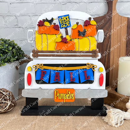 Janet's Craft Corner presents the Fall Hay Bale Interchangeable Insert, a charming piece that beautifully captures fall décor essence. This vintage truck display features pumpkins in the back, a "FALL" banner, and a "Pumpkins" sign. A small "4 pack 25¢" sign is nestled among the pumpkins, all set against a brick background for delightful interchangeable home decor.