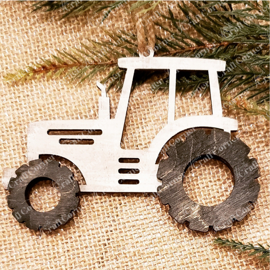 A metal tractor ornament with black wheels hangs on burlap, accented by pine branches—a delightful piece from Janet's Craft Corner Farm Life Christmas Ornaments DIY kit (choice of 4), perfect for festive or everyday decor.