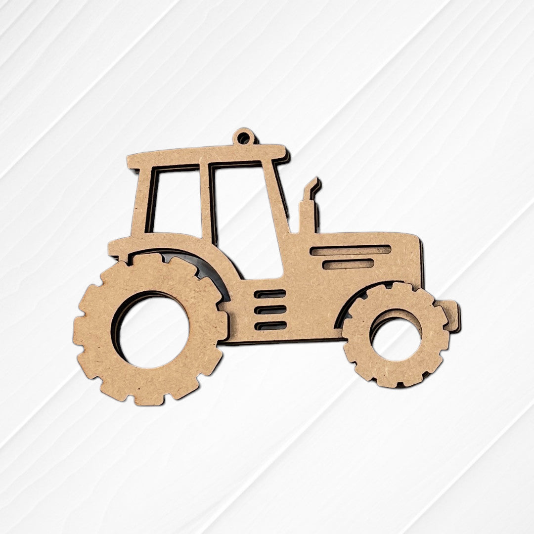 Janet's Craft Corner Farm Life Christmas Ornaments DIY kit—choose from 4 tractor cutouts—shown on a white, diagonally paneled wood surface; perfect for seasonal or farm-themed decor.