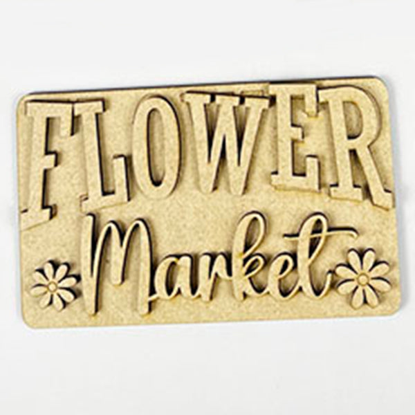 Introducing the Flower Market Mini Shelf Sitters by Janet's Craft Corner. This charming piece features "FLOWER Market" elegantly engraved with hand-painted, decorative letters and is framed by two small flower shapes. The backdrop displays a light wood grain texture, making it a perfect addition to your Flower Market Tiered Tray Kit.