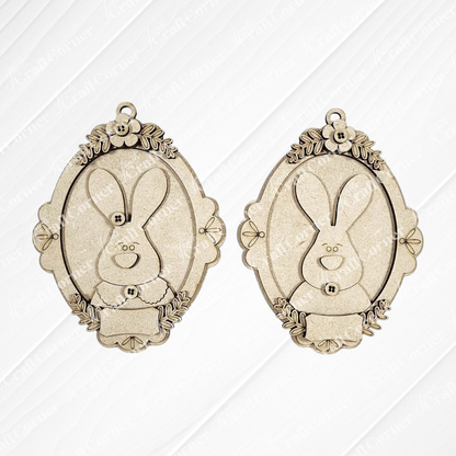 Janet's Craft Corner Framed Easter Bunny Basket Tags are two ornate, oval pendants with floral details and smiling bunny faces—ideal as personalized Easter décor or for DIY craft kits.