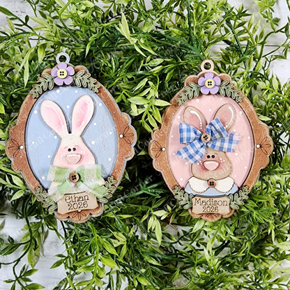 Janet's Craft Corner Framed Easter Bunny Basket Tags—DIY kit with two personalized tags, "Ethan 2026" (blue) and "Madison 2026" (pink), accented with greenery and bows—perfect for Easter décor or basket tags.