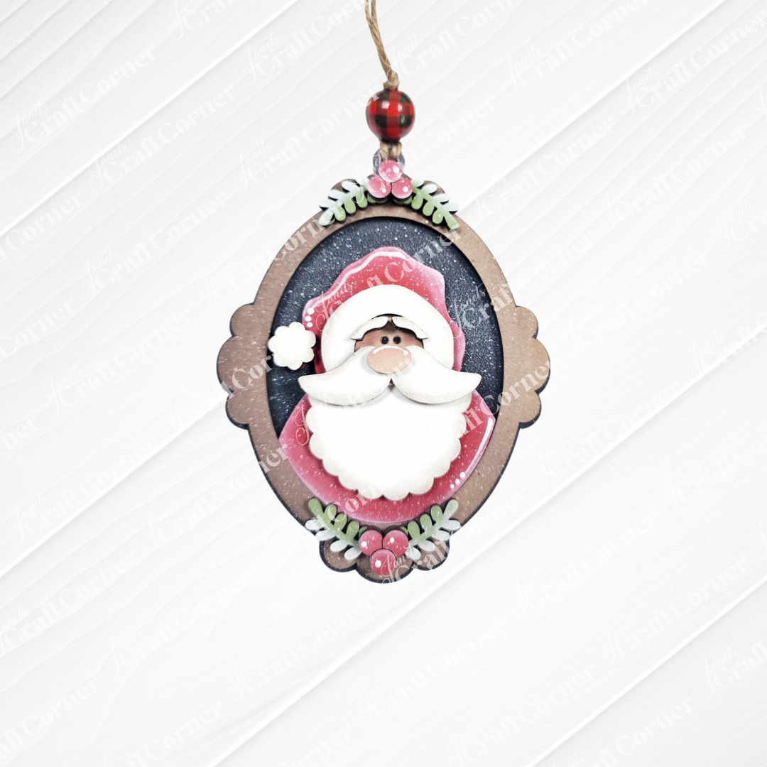 Add festive cheer with Janet's Craft Corner Santa Ornaments—a DIY holiday craft kit (set of 1) featuring a smiling Santa in an oval frame with holly details. Perfect for those who love unique Christmas decor!.