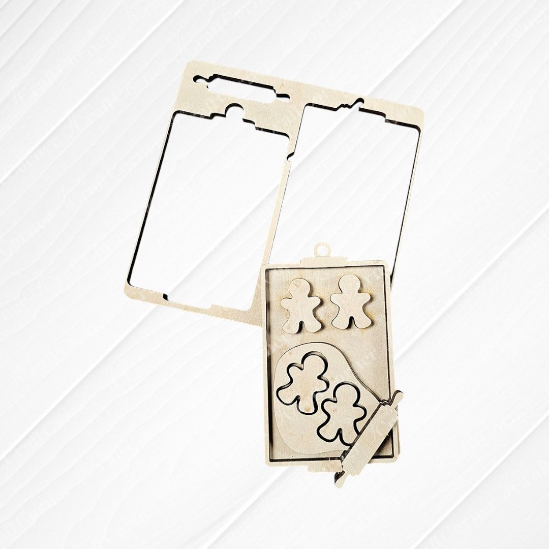 The "Baking Spirits Bright Ornaments - Set of 4 | DIY Decoration Kits" by Janet's Craft Corner is a delightful set that includes two rectangular frames, four gingerbread man shapes, and a small rolling pin, all beautifully arranged on a brown wooden surface. This kit is perfect for crafting your own unique holiday decor with hand-painted wooden cutouts.