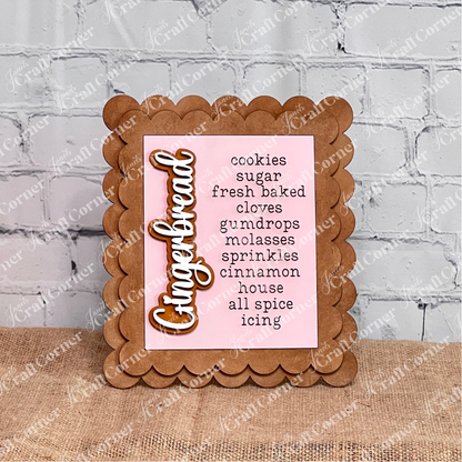 A scalloped brown and pink sign from Janet's Craft Corner reads "Gingerbread" vertically with words like cookies, sugar, cloves, gumdrops, and molasses. Ideal for Single Scallop Trim Farmhouse Frames or as an interchangeable DIY craft display.