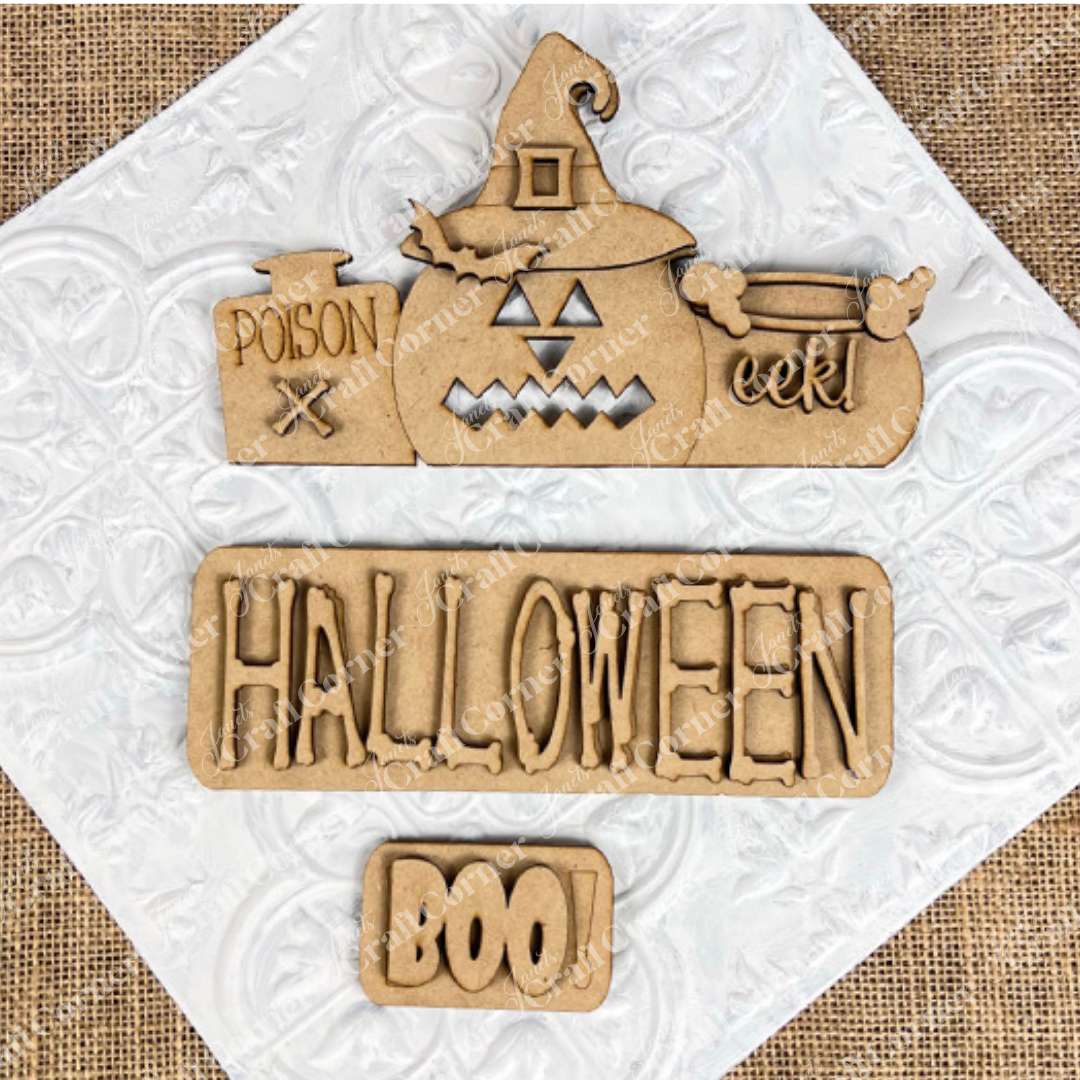 Janet's Craft Corner presents the Halloween Pumpkin Interchangeable Insert—an ideal DIY home decor kit. It features wooden Halloween decorations on a textured white background: a pumpkin adorned with a witch hat labeled "poison" and "eek!", alongside a sign that reads "HALLOWEEN," and a small plaque with the word "BOO!" All elements rest atop burlap fabric, offering perfect pieces for interchangeable craft inserts.