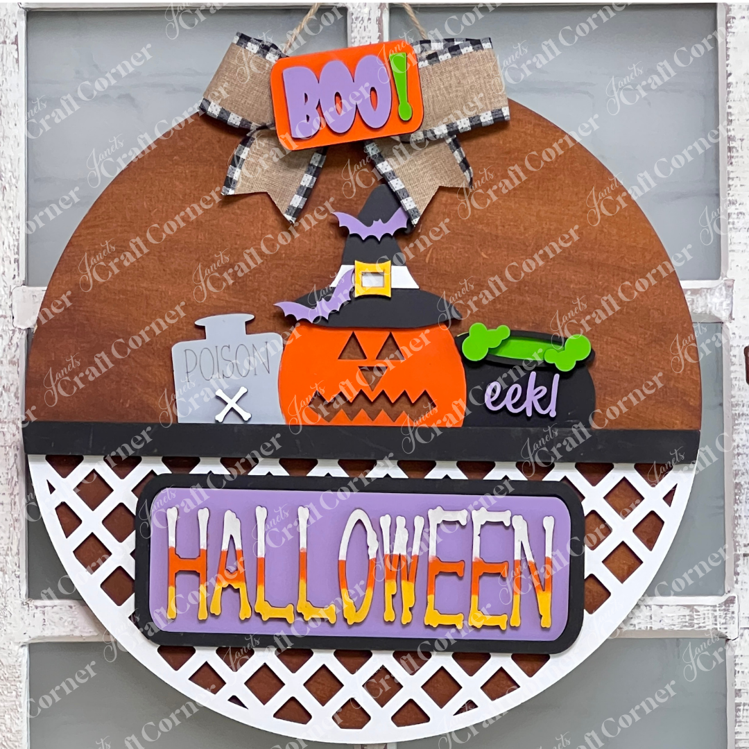 Introducing the Halloween Pumpkin Interchangeable Insert from Janet's Craft Corner, a perfect addition to your DIY home decor kit. This round door sign showcases a charming pumpkin wearing a witch hat, a cauldron that exclaims "eek!", and the bold word "BOO!" A delightful bow adorns the top, while "HALLOWEEN" elegantly spans across the lattice bottom, making it ideal for festive interchangeable craft inserts.