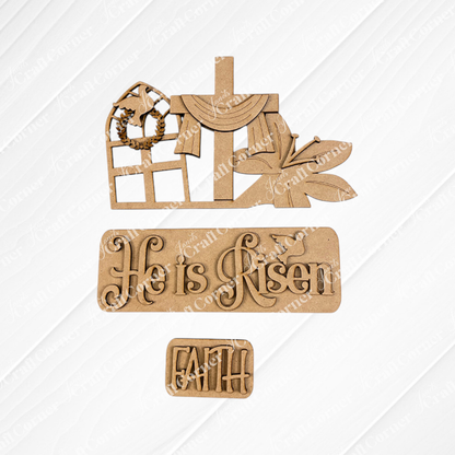 Janet's Craft Corner offers the "He is Risen Interchangeable Insert" DIY home decor kit, which showcases wooden cutouts of a draped cross, a butterfly, and a window featuring a dove and wreath. The kit includes two plaques with the messages "He is Risen" and "Faith," designed to be interchangeable on a textured white and burlap background for an Easter-themed craft experience.