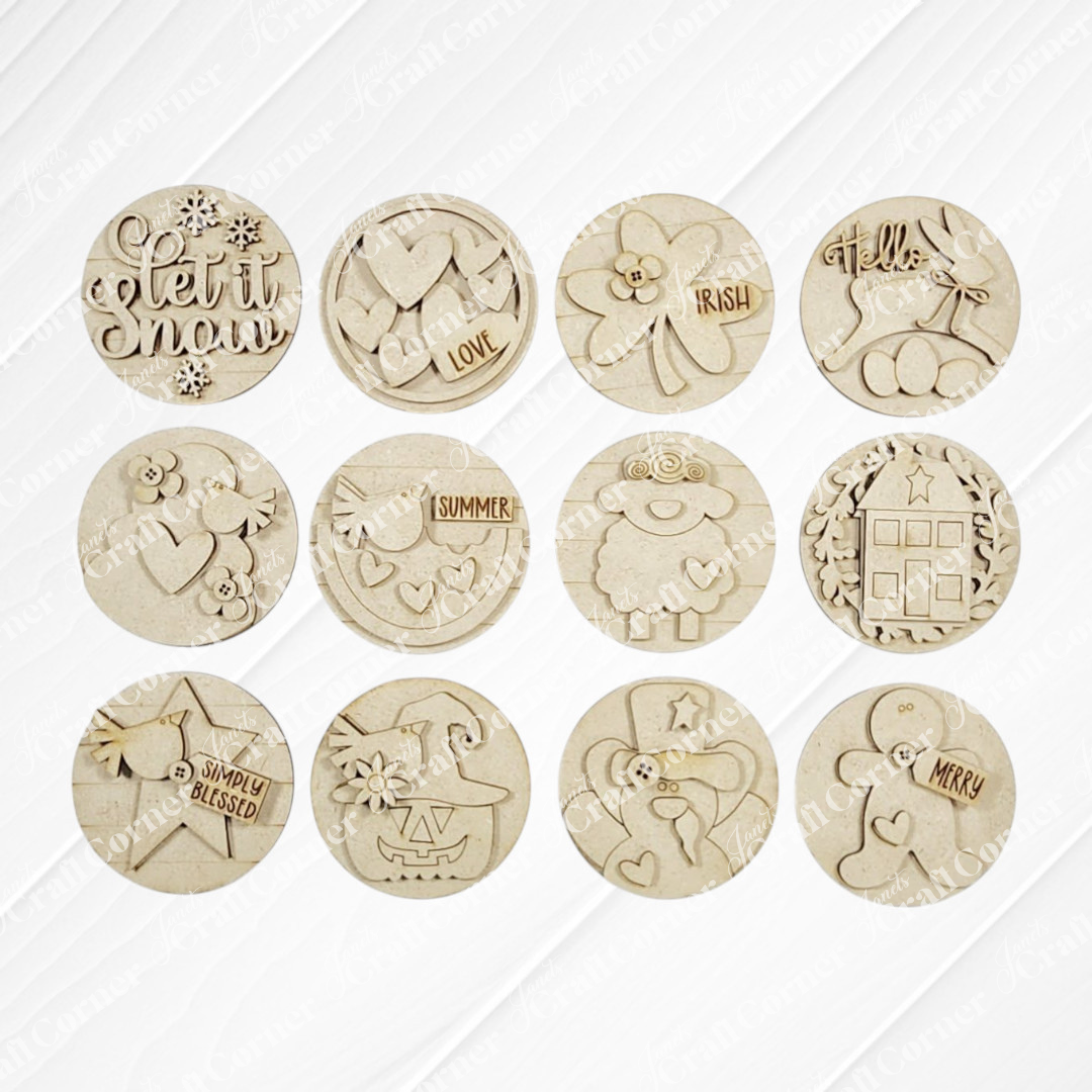 Twelve round wooden tokens from Janet’s Craft Corner, designed for the Shaker Tea Light Box Interchangeable Set DIY kit, feature seasonal motifs—snowflakes, hearts, clover, reindeer, pumpkin—to enhance your farmhouse decor year-round.