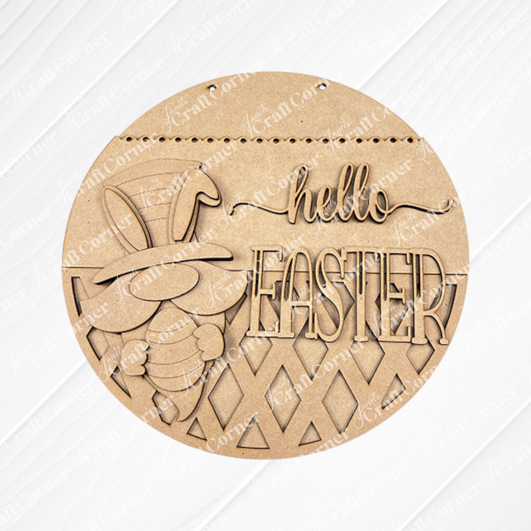 The Hello Easter Gnome Wall Hanger from Janet's Craft Corner is a DIY decor craft kit featuring a laser-cut bunny with an egg and top hat. Set against textured brown fabric, it's perfect for adding seasonal flair to your home.