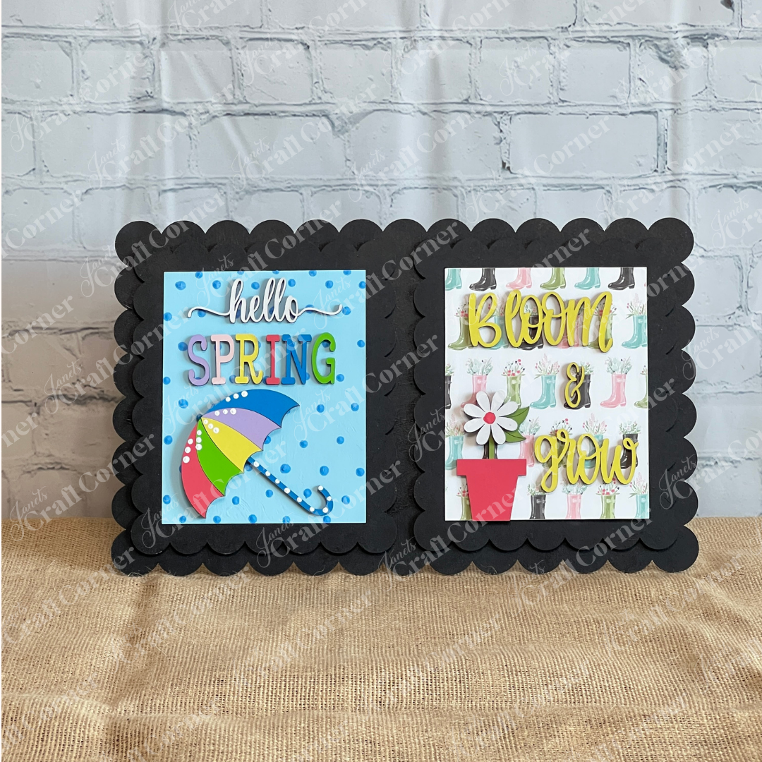 Add spring flair to your tiered tray with Janet’s Craft Corner Spring Switchable Farmhouse Signs DIY Kit—includes two colorful cards: “hello SPRING” with umbrella and “BLOOM & grow” with flowerpot and boots, on a black scalloped frame.