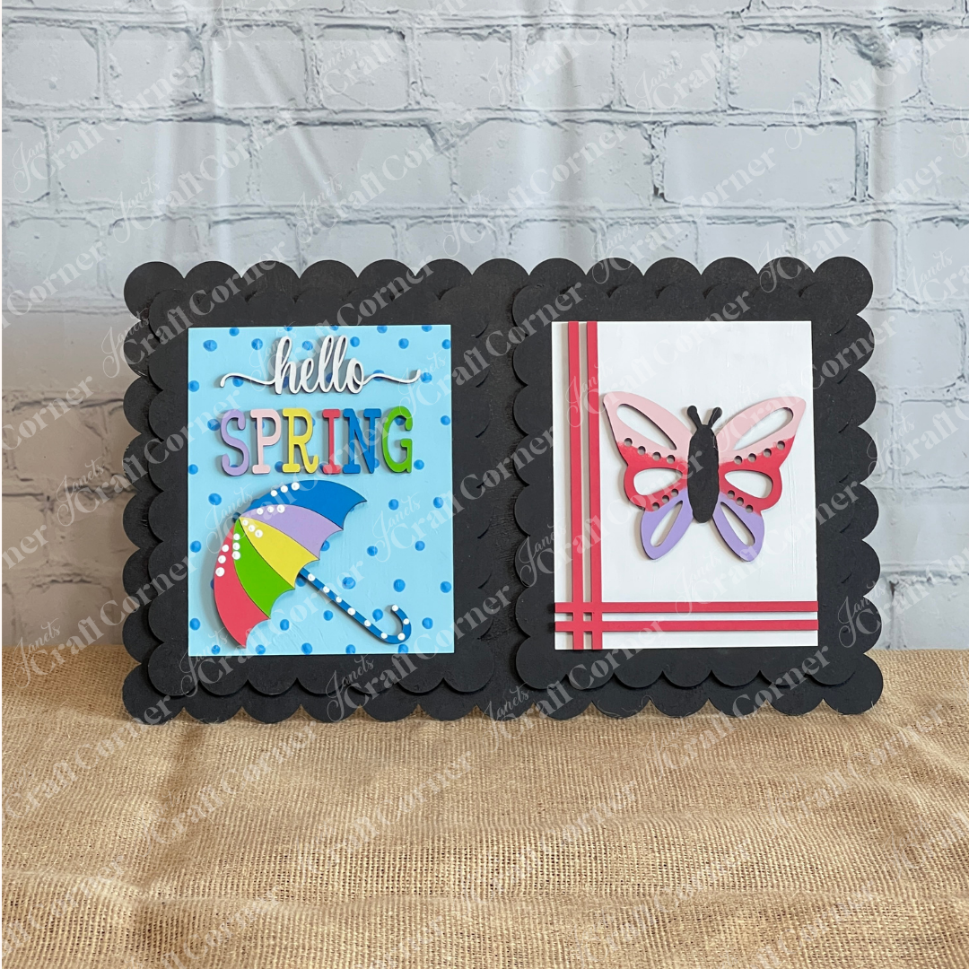 Handmade by Janet's Craft Corner, the Spring Switchable Farmhouse Signs DIY Kit features a scalloped black border, colorful umbrella, "hello SPRING" text, and butterfly—perfect for tiered trays or pairing with lavender decor.