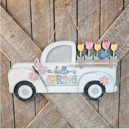 Immerse yourself in the spirit of spring with Janet's Craft Corner's charming "Hello Spring Truck Sign." This delightful wooden decoration showcases a vintage truck adorned with "Hello Spring," its bed overflowing with vibrant tulips and a butterfly, all against a lovely rustic wood backdrop.