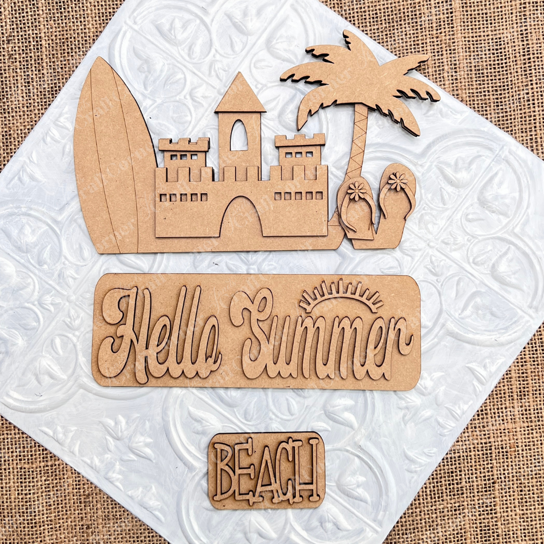 The Summer Beach Interchangeable Insert, a DIY home decor kit by Janet's Craft Corner, features wooden beach-themed cutouts on a textured surface. This versatile decor set includes a surfboard, sandcastle, palm tree, flip-flops, and signs engraved with "Hello Summer" and "Beach." The burlap background with a white tile pattern adds charm and adaptability to any space.